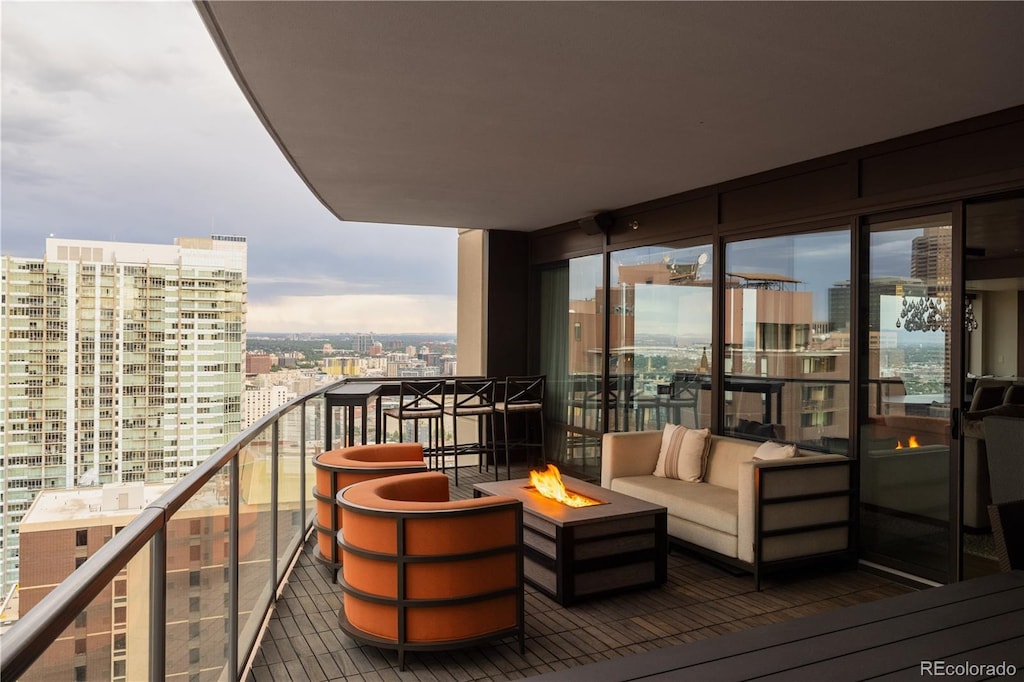 balcony with an outdoor living space with a fire pit