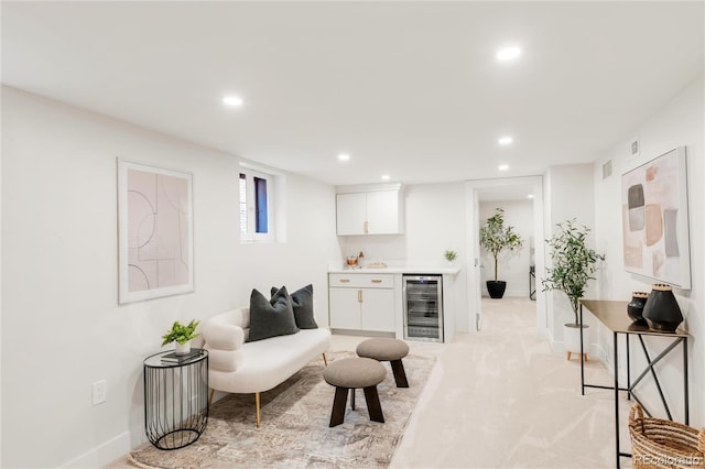 living area featuring bar, beverage cooler, recessed lighting, baseboards, and visible vents