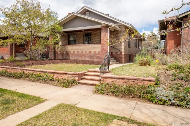 view of front of property featuring brick siding and covered porch