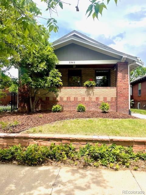 3361 W 36th Ave, Denver, CO 80211 - view of front facade with brick siding, covered porch, and fence