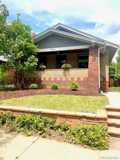 3361 W 36th Ave, Denver, CO 80211 - view of front of home featuring brick siding, a porch, and fence