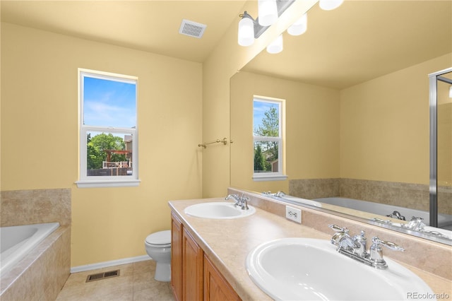 bathroom featuring plenty of natural light, a garden tub, baseboards, and tile patterned floors