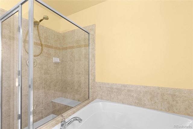 full bathroom with a garden tub and a stall shower