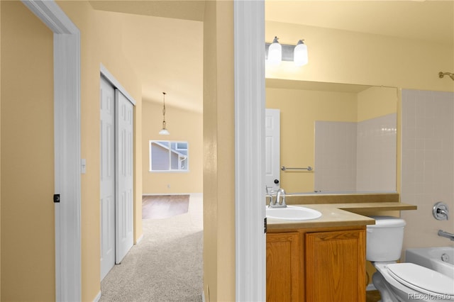 bathroom with vanity, toilet, and tub / shower combination
