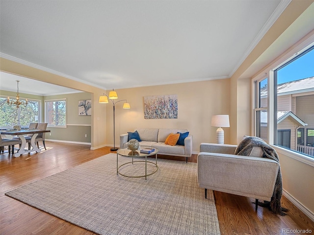 4228 Scenic Village Dr, Evergreen, CO 80439 - living room with wood finished floors, baseboards, crown molding, and a chandelier