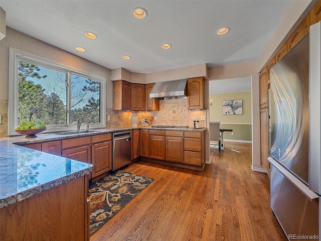 4228 Scenic Village Dr, Evergreen, CO 80439 - kitchen with appliances with stainless steel finishes, brown cabinets, recessed lighting, backsplash, and dark wood-type flooring