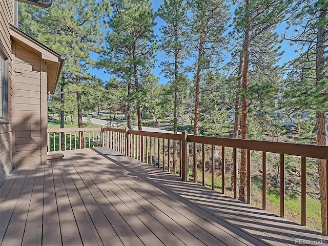 4228 Scenic Village Dr, Evergreen, CO 80439 - wooden deck with view of wooded area