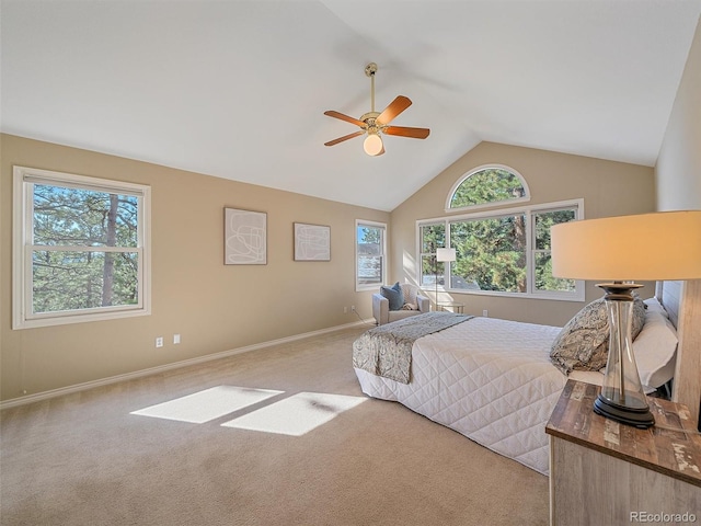4228 Scenic Village Dr, Evergreen, CO 80439 - carpeted bedroom featuring multiple windows, baseboards, a ceiling fan, and high vaulted ceiling