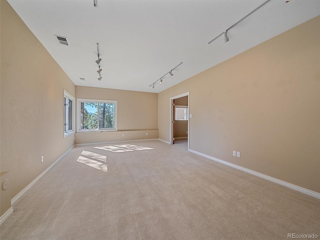 4228 Scenic Village Dr, Evergreen, CO 80439 - unfurnished room featuring rail lighting, light colored carpet, and baseboards