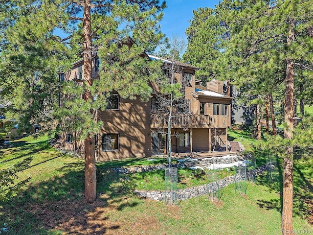 4228 Scenic Village Dr, Evergreen, CO 80439 - back of property featuring a deck, a yard, and a chimney