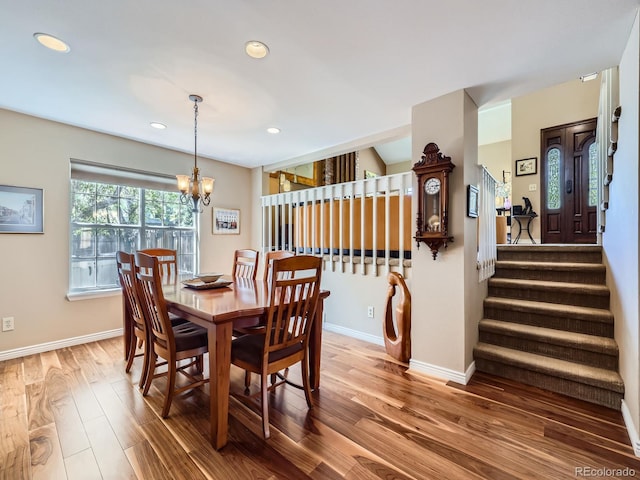 dining area with stairway, wood finished floors, a chandelier, recessed lighting, and baseboards