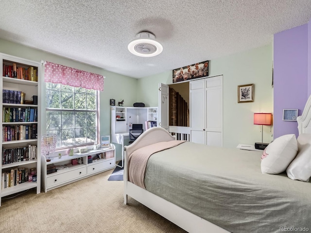 carpeted bedroom featuring a textured ceiling