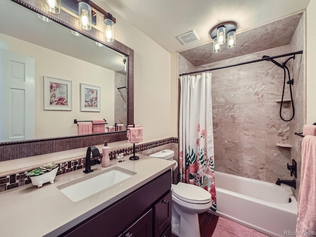 bathroom featuring shower / bath combo with shower curtain, vanity, and toilet