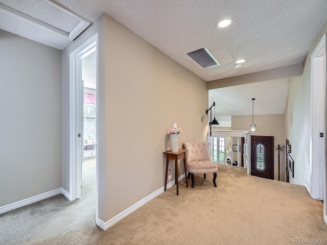 living area featuring carpet flooring, a textured ceiling, baseboards, and recessed lighting