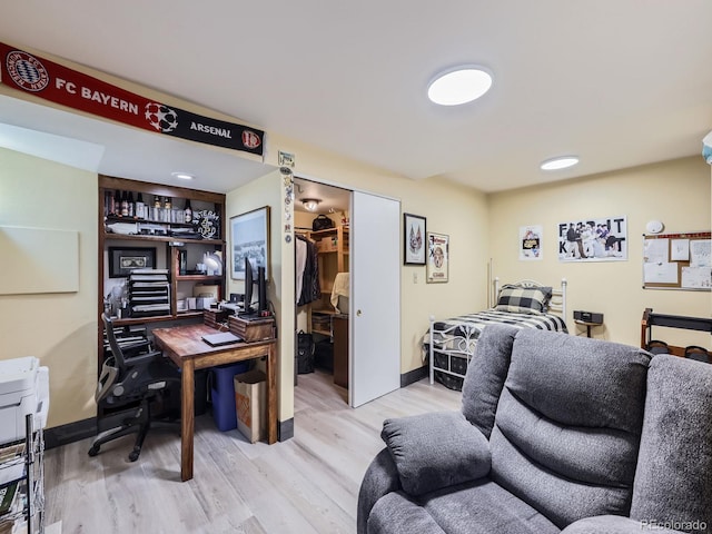 office area with light wood-type flooring and baseboards
