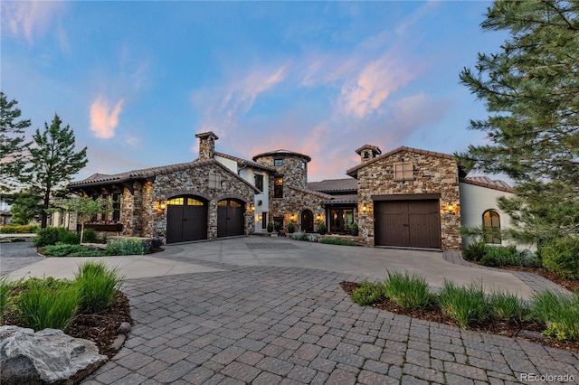 7208 Raphael Ln, Littleton, CO 80125 - view of front of house featuring stone siding, an attached garage, curved driveway, a tile roof, and a chimney