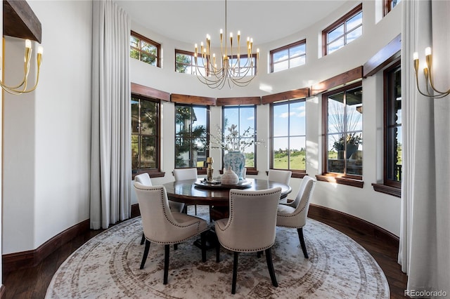 7208 Raphael Ln, Littleton, CO 80125 - dining room with a chandelier, baseboards, dark wood finished floors, and a towering ceiling