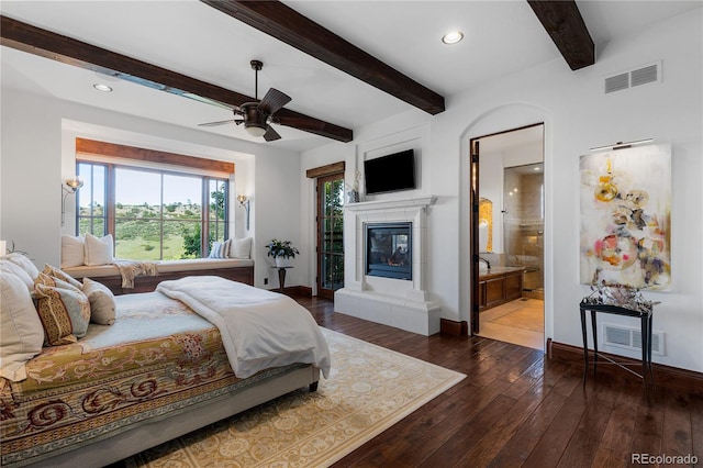 7208 Raphael Ln, Littleton, CO 80125 - bedroom featuring multiple windows, a tile fireplace, dark wood-type flooring, baseboards, and beamed ceiling