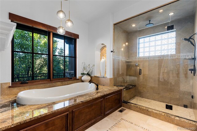 7208 Raphael Ln, Littleton, CO 80125 - full bathroom featuring a shower stall, a garden tub, and tile patterned flooring