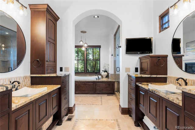 7208 Raphael Ln, Littleton, CO 80125 - full bath featuring a stall shower, two vanities, a garden tub, tile patterned flooring, and recessed lighting