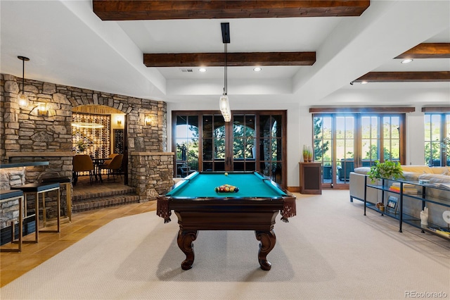 7208 Raphael Ln, Littleton, CO 80125 - rec room with billiards table, beamed ceiling, arched walkways, french doors, and a stone fireplace