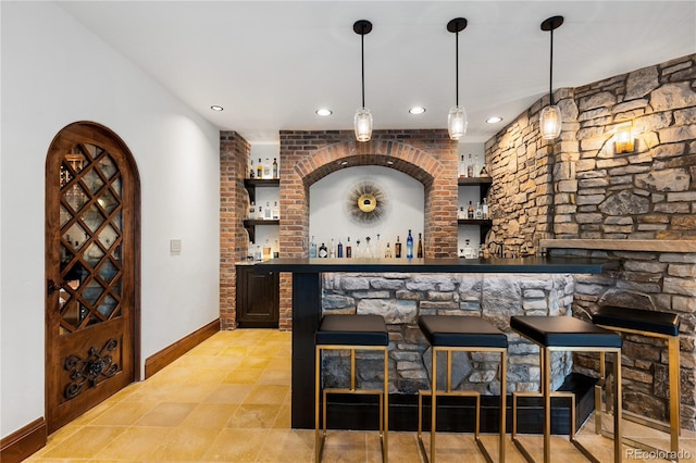 7208 Raphael Ln, Littleton, CO 80125 - indoor bar featuring baseboards, recessed lighting, and hanging light fixtures