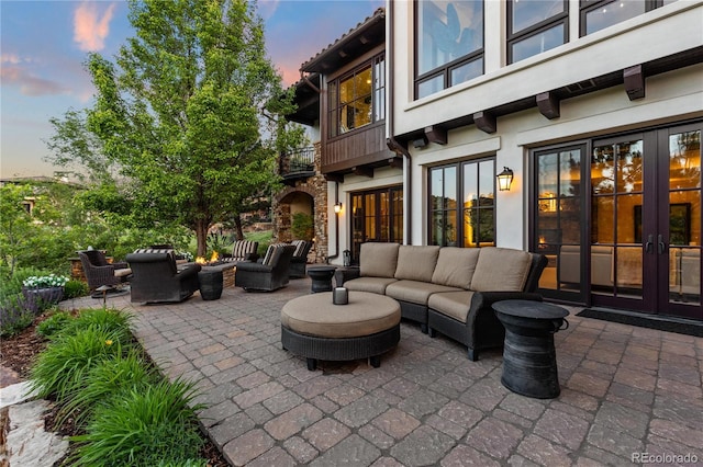 7208 Raphael Ln, Littleton, CO 80125 - patio terrace at dusk with french doors, a balcony, outdoor lounge area, and a patio