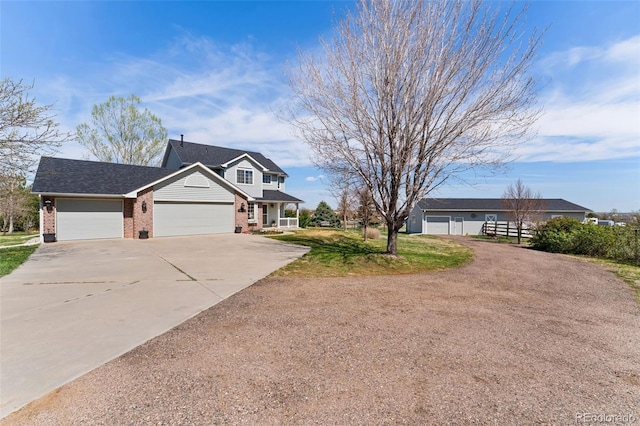 view of front of home with brick siding, concrete driveway, an attached garage, and a porch