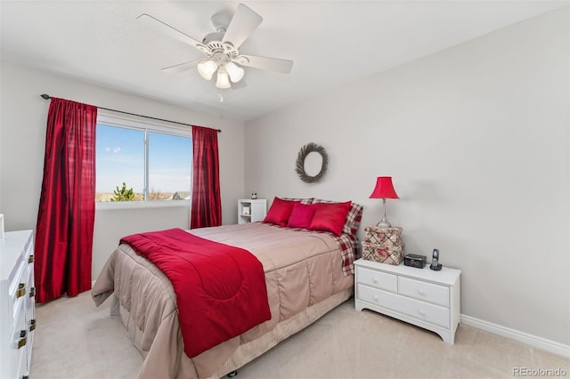 bedroom with light carpet, a ceiling fan, and baseboards