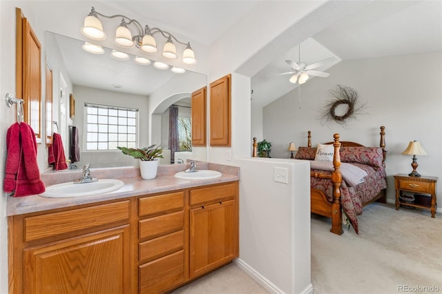 bathroom featuring ceiling fan, double vanity, and vaulted ceiling