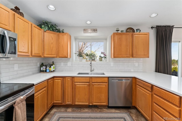 29145 E 160th Ct, Brighton, CO 80603 - kitchen with stainless steel appliances, a sink, light countertops, backsplash, and recessed lighting