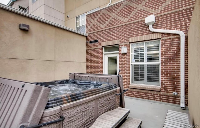 view of patio / terrace with a hot tub