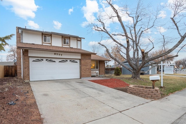 view of front facade with a garage, driveway, brick siding, and fence