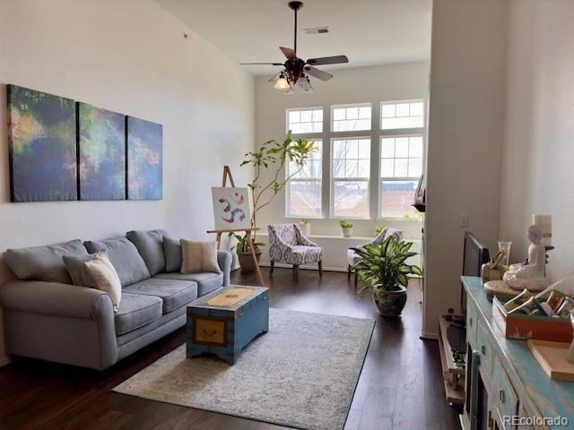 living room featuring dark hardwood / wood-style flooring and ceiling fan