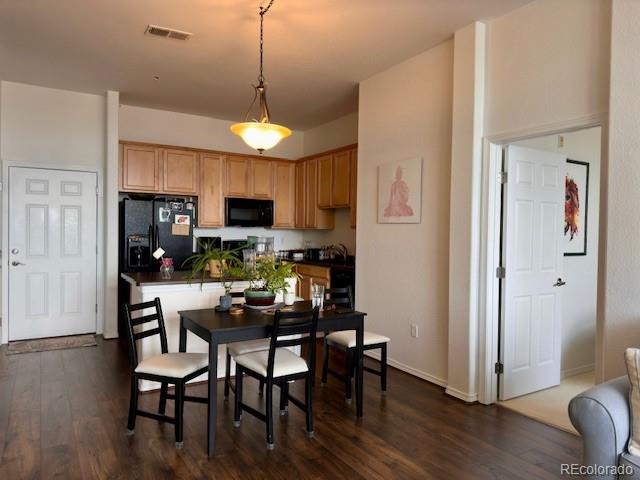 dining room with dark hardwood / wood-style flooring