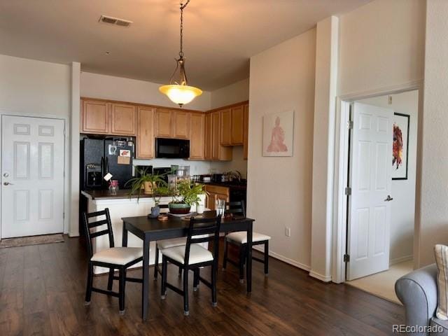 dining room featuring dark hardwood / wood-style flooring