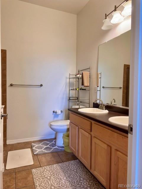 bathroom with vanity, tile patterned floors, and toilet