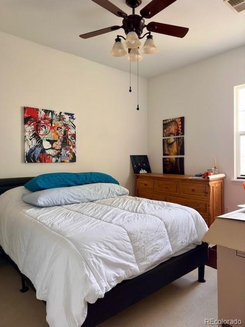 bedroom featuring light colored carpet and ceiling fan