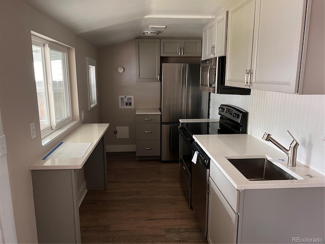 4875 Lowell Blvd, Denver, CO 80221 - kitchen featuring dark wood-style flooring, stainless steel appliances, light countertops, gray cabinetry, and vaulted ceiling