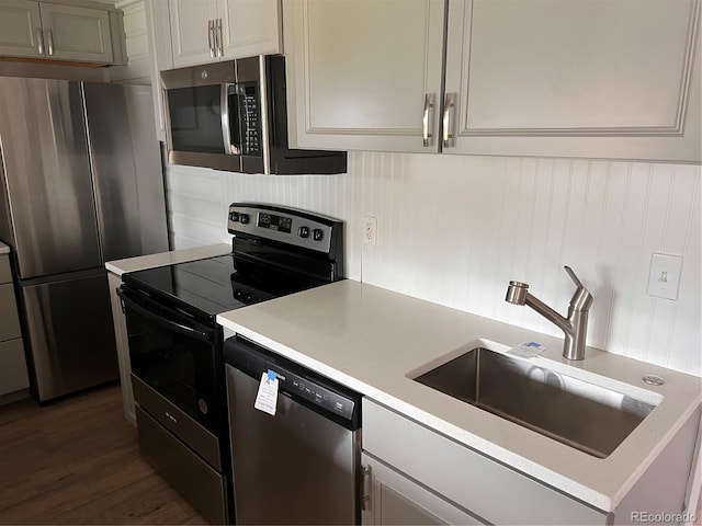 4875 Lowell Blvd, Denver, CO 80221 - kitchen with stainless steel appliances, light countertops, and dark wood-style floors