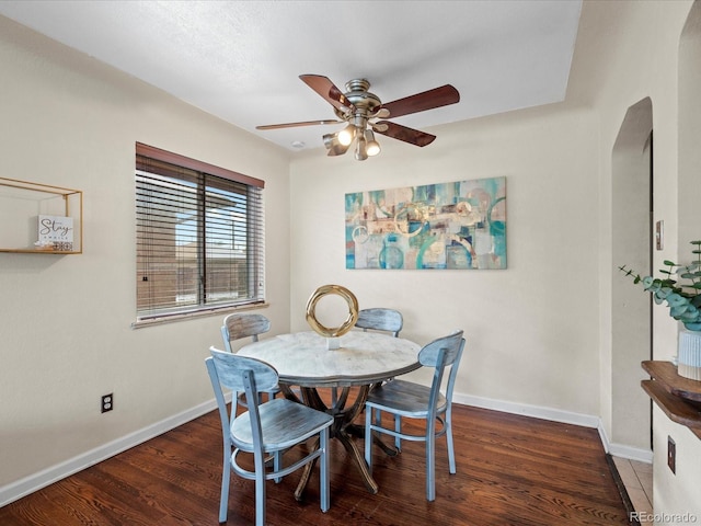 dining room with ceiling fan and dark hardwood / wood-style flooring