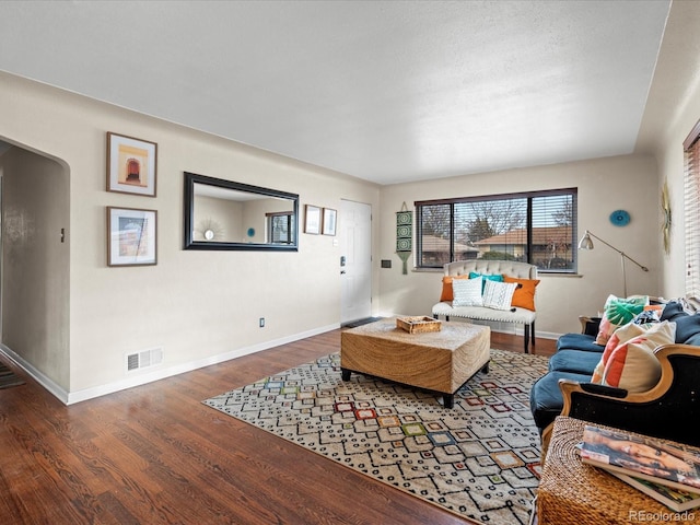 living room with dark hardwood / wood-style flooring