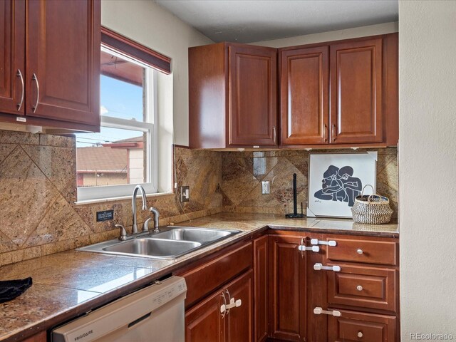 kitchen featuring dishwasher, tasteful backsplash, and sink