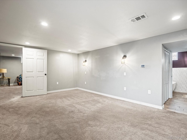 unfurnished room with light carpet