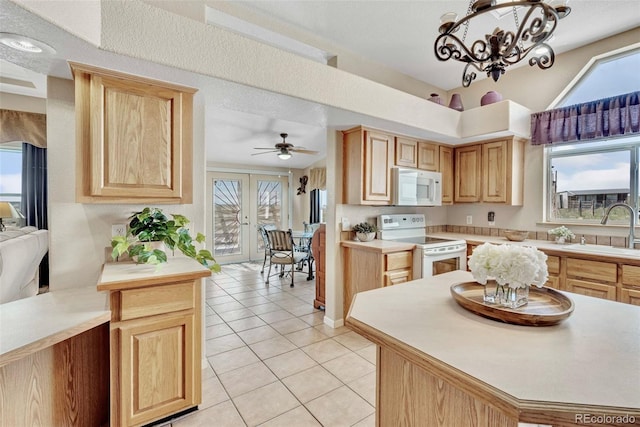 5129 S Tom Bay Rd, Bennett, CO 80102 - kitchen with light tile patterned floors, white appliances, light brown cabinetry, and a sink