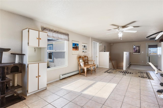 5129 S Tom Bay Rd, Bennett, CO 80102 - interior space with light tile patterned floors, plenty of natural light, a ceiling fan, and baseboard heating