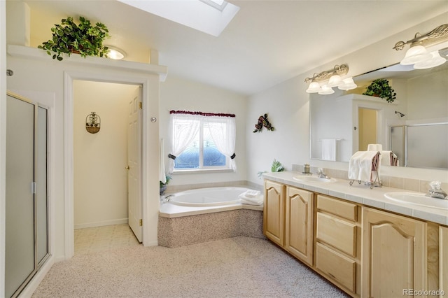 688 Tiara Rd, Lake George, CO 80827 - bathroom featuring a shower stall, vaulted ceiling, a skylight, a garden tub, and double vanity