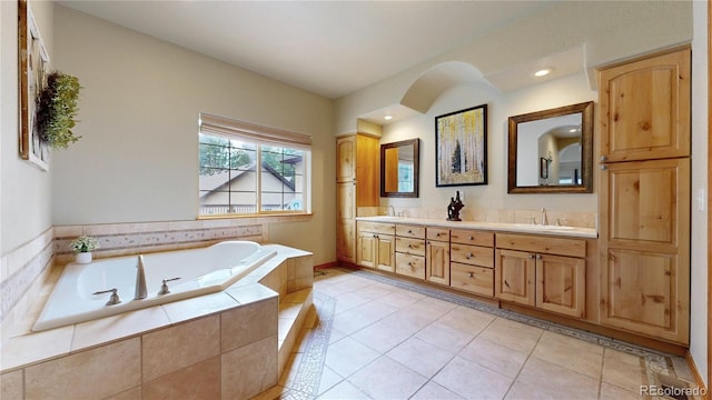 bathroom with double vanity, a garden tub, tile patterned floors, and recessed lighting