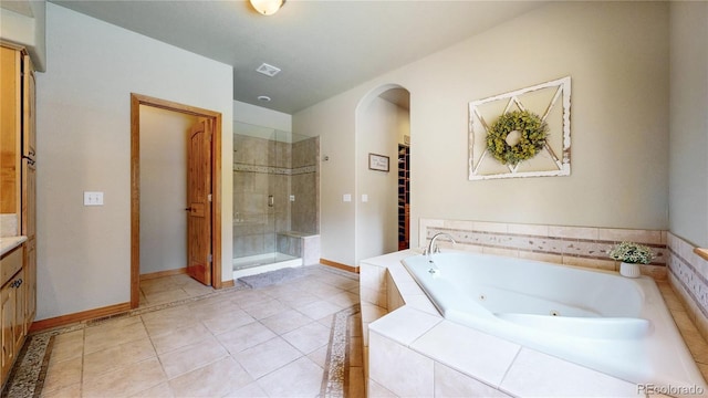bathroom with a shower stall, a whirlpool tub, baseboards, and vanity
