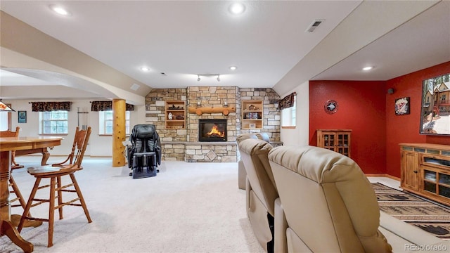 living room with recessed lighting, a stone fireplace, carpet, arched walkways, and baseboards